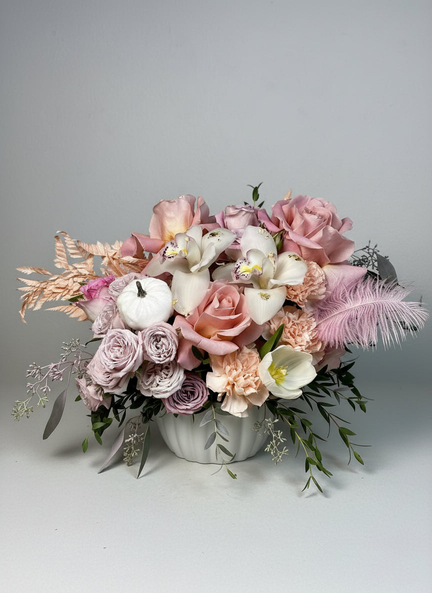 Bouquet of flowers with pumpkins on a wooden surface
